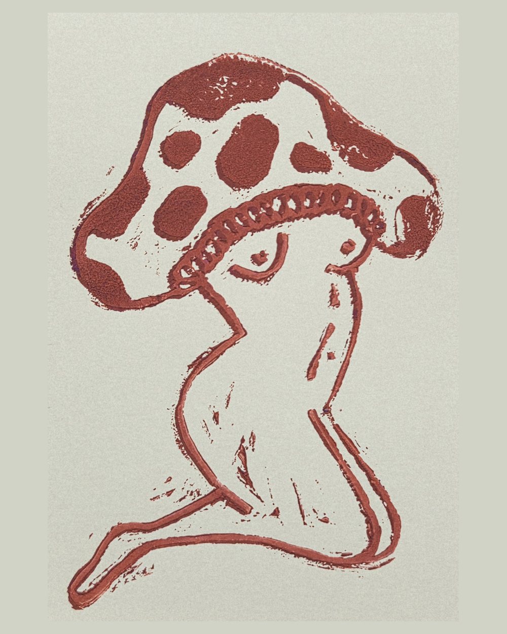 Linocut in brick red of a spotted mushroom with a gilled cap and a curling stem, drawn in a single continuous line.